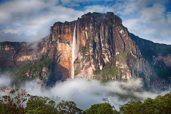 بلند‌ترین آبشار دنیا: آبشار آنجل (Angel)، ونزوئلا
اگر چه آبشار آنخل در جنگل‌های انبوه دور افتاده‌ای از ونزوئلا واقع شده است و دسترسی به آن به سادگی امکان پذیر نیست، اما همچنان به عنوان یکی از زیبا‌ترین مکان‌های توریستی کشور ونزوئلا به حساب می‌آید و تصاویری که از آن می‌بینید به سادگی گواه بر زیبایی فوق العاده و ارتفاع بلند این آبشار است. آبشار در حدود ۳۲۱۲ فوت ارتفاع دارد و شامل ۲۶۴۸ فوت شیب تند و نیم مایل آبشار در سطحی پایین‌تر و البته با شیبی نسبتا تند است. نام این آبشار برگرفته شده از نام جیمز آنجل، کاوشگر آمریکایی است که هواپیمای خود را نزدیک این آبشار بعد از شناسایی در سال ۱۹۳۵ میلادی فرود آورد.