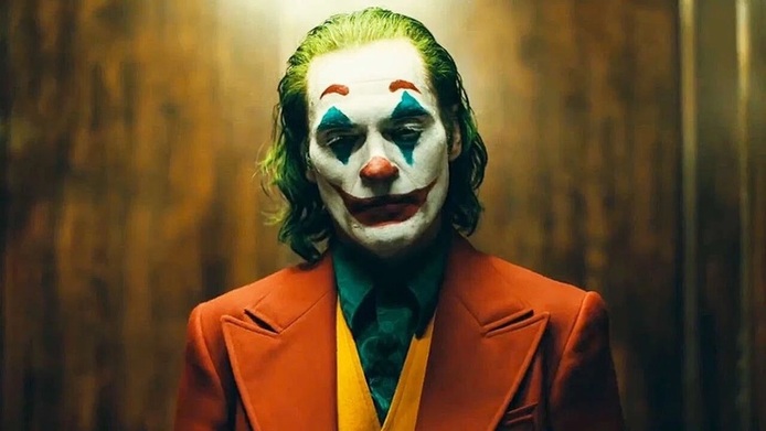 جوکر | Joker

نمره منتقدان: ۶۸ از ۱۰۰

«جوکر» یکی از تاثیرگذارترین فیلم‌های درام سال ۲۰۱۹ است که می‌تواند در لیست بهترین فیلم‌های دهه ۲۰۱۰ میلادی هم قرار بگیرد. اگرچه این فیلم براساس رمان‌های مصور ساخته شده، اما تفاوت‌های بسیاری با بیشتر فیلم‌های کتاب‌های مصور دارد. این فیلم واقع‌گرایانه‌ترین و مدرن‌ترین تصور ممکن از ضدقهرمان رمان‌های مصور انتشارات دی‌سی را به تماشاگر ارائه می‌دهد. استقبال از این فیلم به حدی بود که قرار است دنباله آن هم به زودی ساخته شود.

خلاصه داستان: آرتور فلک یک کمدین ساده است که بیماری‌های روانی متعددی دارد. او گاهی از خنده‌های بدون اختیارش فرصت نفس‌کشیدن ندارد و گاهی هم از بغض درون گلویش به دیوانگی می‌رسد. آرتور هرگز توسط اطرافیانش پذیرفته نمی‌شود. او که از این زندگی ناامیدانه خسته شده، تصمیم می‌گیرد همه باورهایش را کنار بگذارد و با نفرتی باورنکردنی در برابر قوانین ظالمانه جامعه‌اش قرار بگیرد.